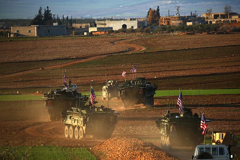 A convoy of US forces armoured vehicles drives near the village of Yalanli, on the western outskirts of the northern Syrian city of Manbij which is currently controlled by YPG terrorists, on March 5, 2017. (AFP Photo)
