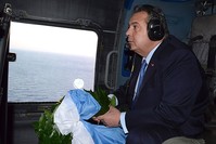 Greek Defense Minister Panos Kammenos prepares to throw a wreath over the area of the Imia Islets in the Agean Sea from a helicopter on Feb. 2, 2017. (AFP File Photo)