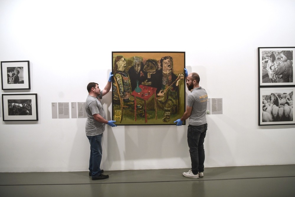 Workers take down a painting at Istanbul Modern, which will reopen in a historic Istanbul mansion in the central Beyoglu district in May.