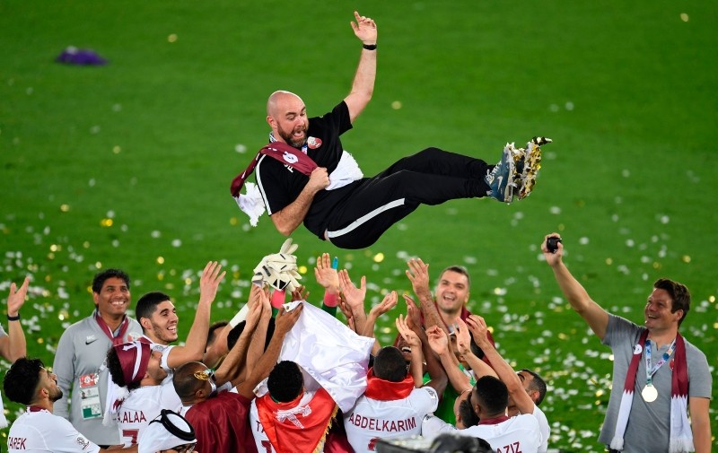  Qatar's coach Felix Sanchez is thrown in the air as his team celebrates their win in the 2019 AFC Asian Cup final football match (AFP Photo)