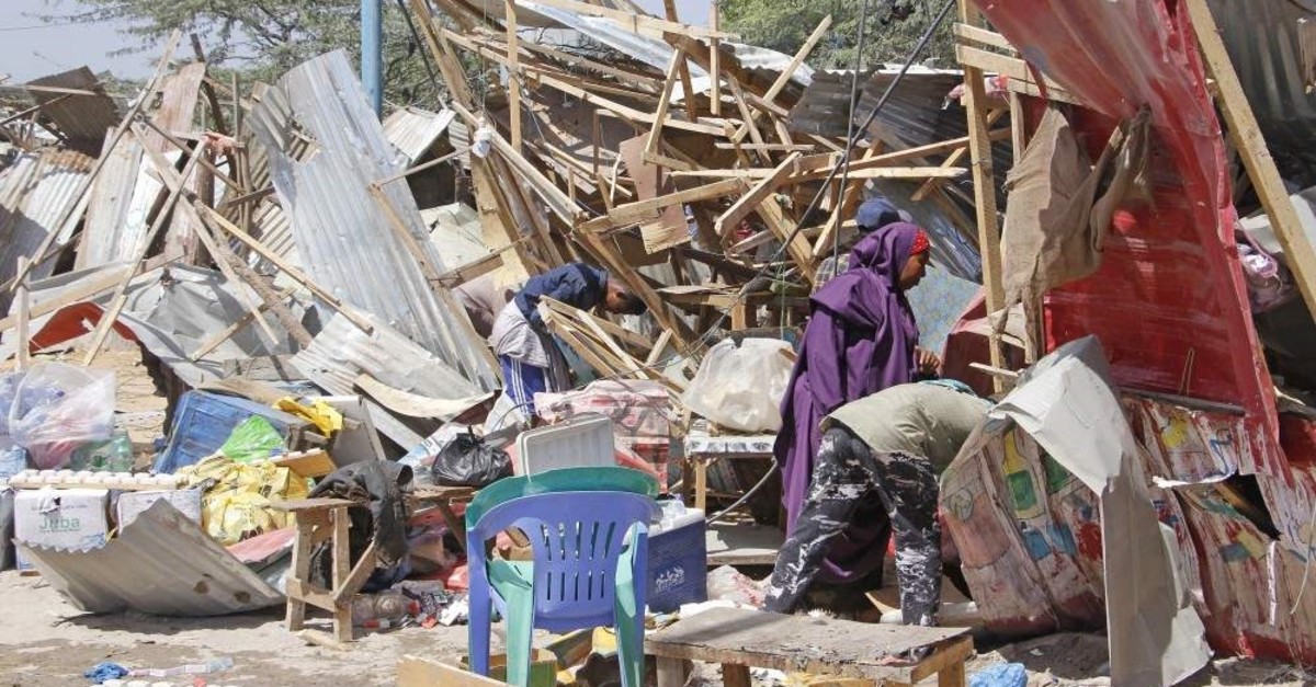 Somalis salvage goods after shops were destroyed in a car bomb in Mogadishu, Somalia, Dec. 28, 2019 (AP Photo)