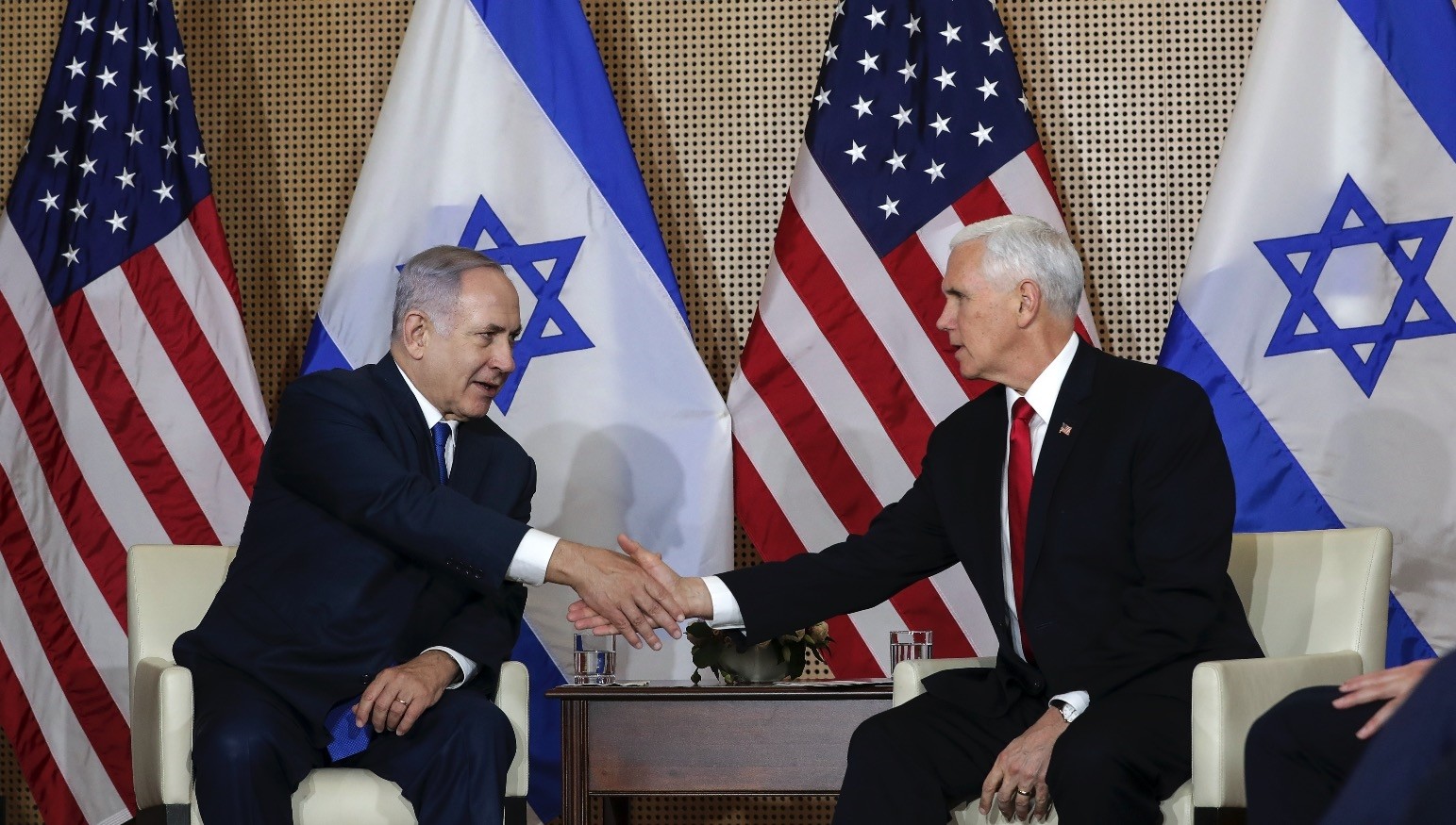 Israeli Prime Minister Benjamin Netanyahu (L) shakes hands with U.S. Vice President Mike Pence at a bilateral meeting in Warsaw, Poland, Feb. 14, 2019.