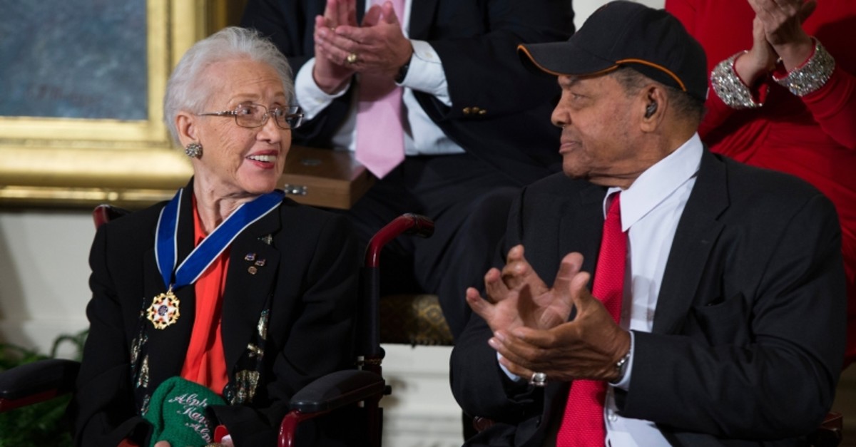In a Nov. 24, 2015 file photo, Willie Mays, right, applauds NASA mathematician Katherine Johnson, after she received the Presidential Medal of Freedom from President Barack Obama during a ceremony in the East Room of the White House. (AP Photo)