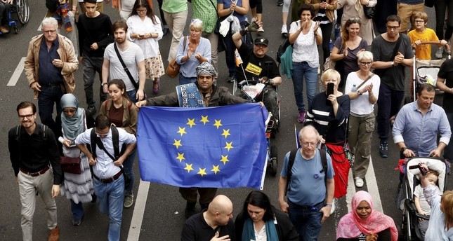 People take part in 'The Not With Us' rally against the increasing Islamophobic and extremist attacks across the European continent, Cologne, Germany, June 17.