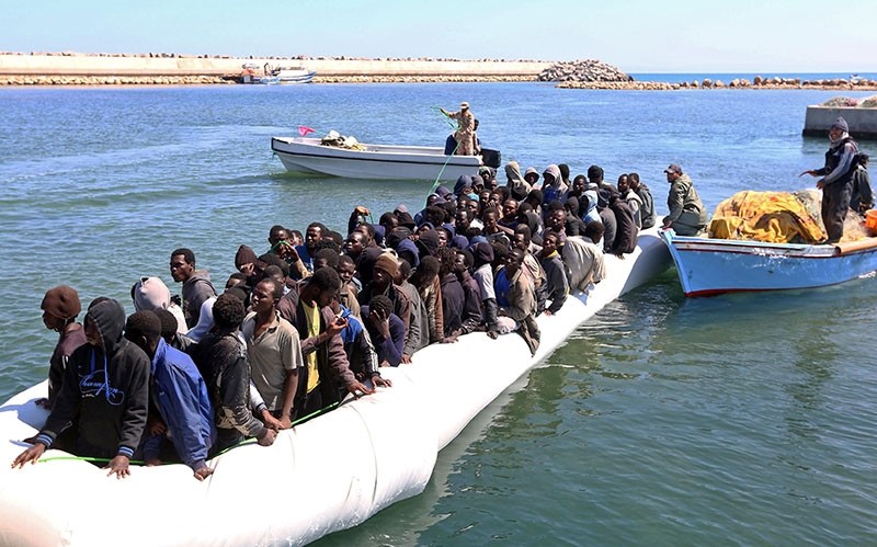 Illegal migrants from Africa arrive on shore after being rescued by Libyan coast guards rescued at sea, off the coastal town of Guarabouli. (AFP Photo)