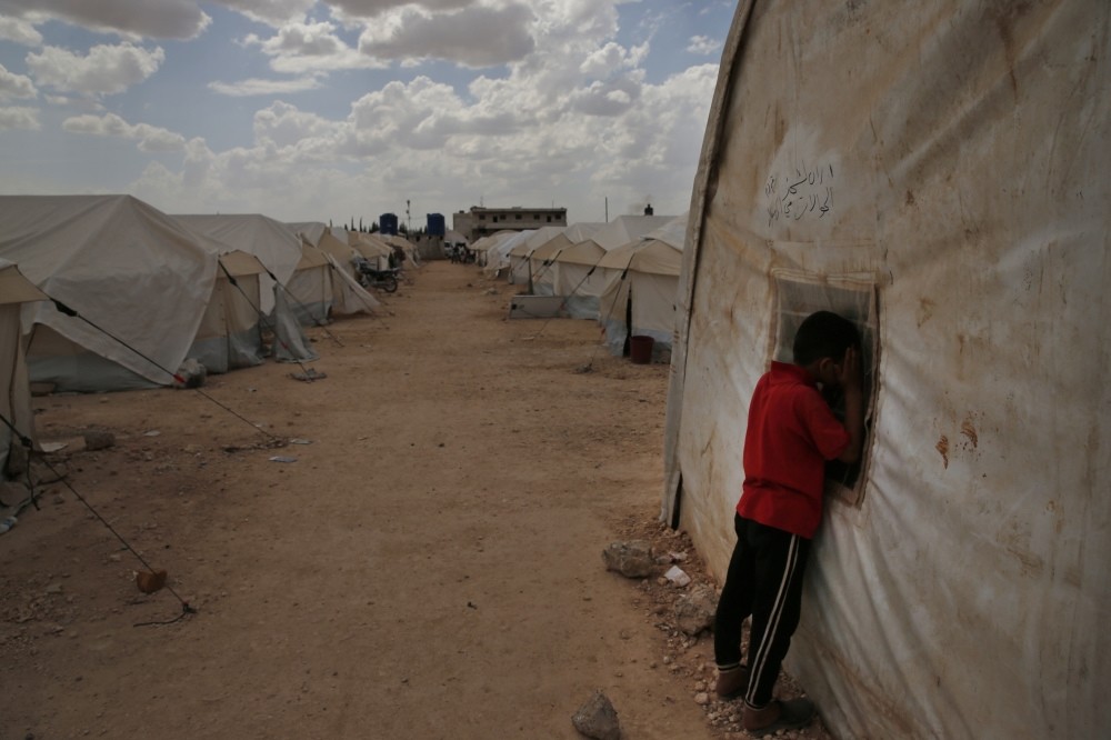 A Syrian child peeks inside a tent during leisure activities at a camp for internally displaced people in al-Bab, northern Syria, May 29.