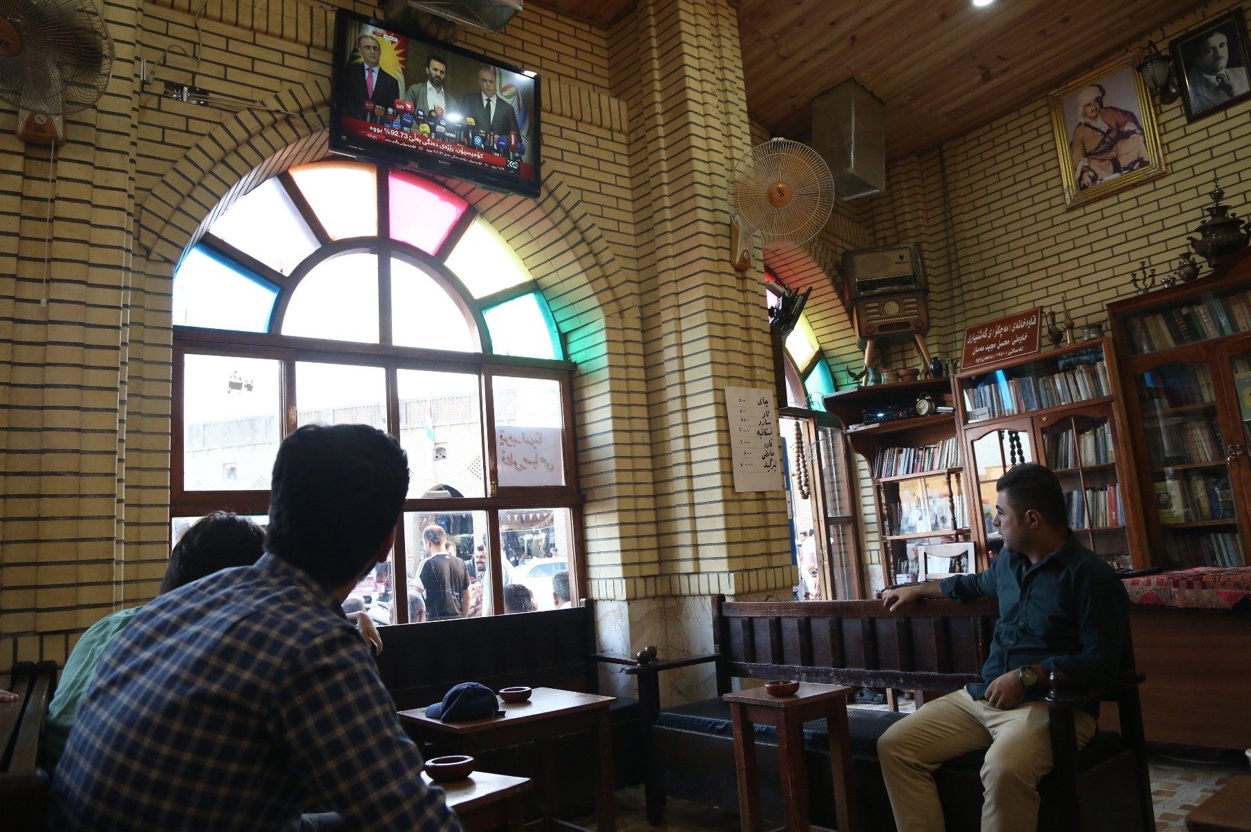 Kurdish people at a popular cafe in Irbil watch the press conference where the results of the KRG independence referendum are announced, Sept. 27.