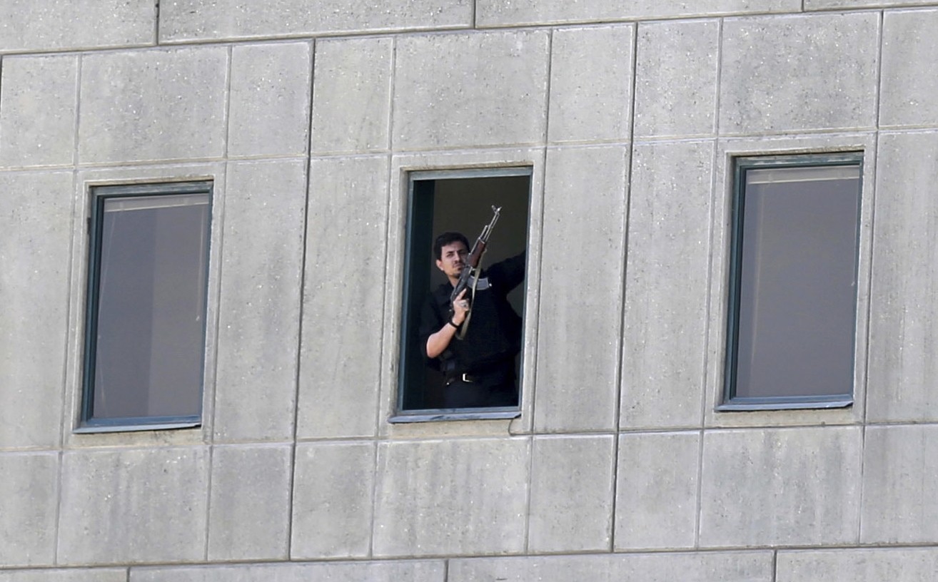 Armed man stands in a window of the parliament building during an attack by militants in Tehran, Iran. (Fars News Agency via AP)