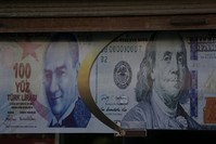 Posters of the Turkish lira and U.S. dollar as seen on a currency exchange shop.