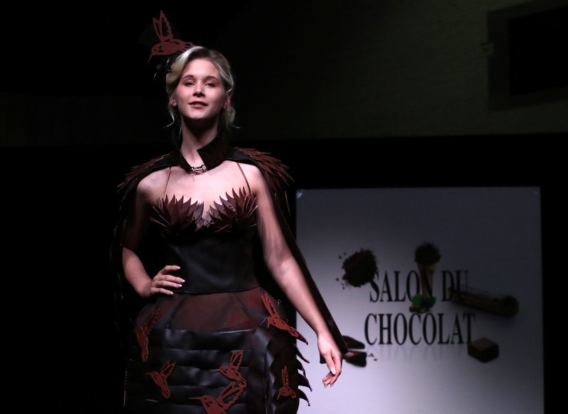 A model dressed in an outfit made with chocolate presents a creation at the