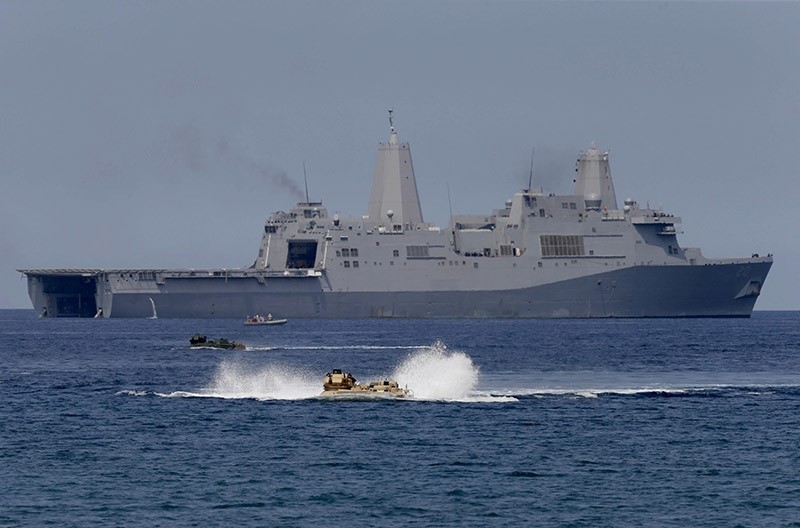 U.S. Navy's amphibious assault vehicles with Philippine and U.S. troops on board maneuver in the waters during a combined assault exercise. (AP Photo)