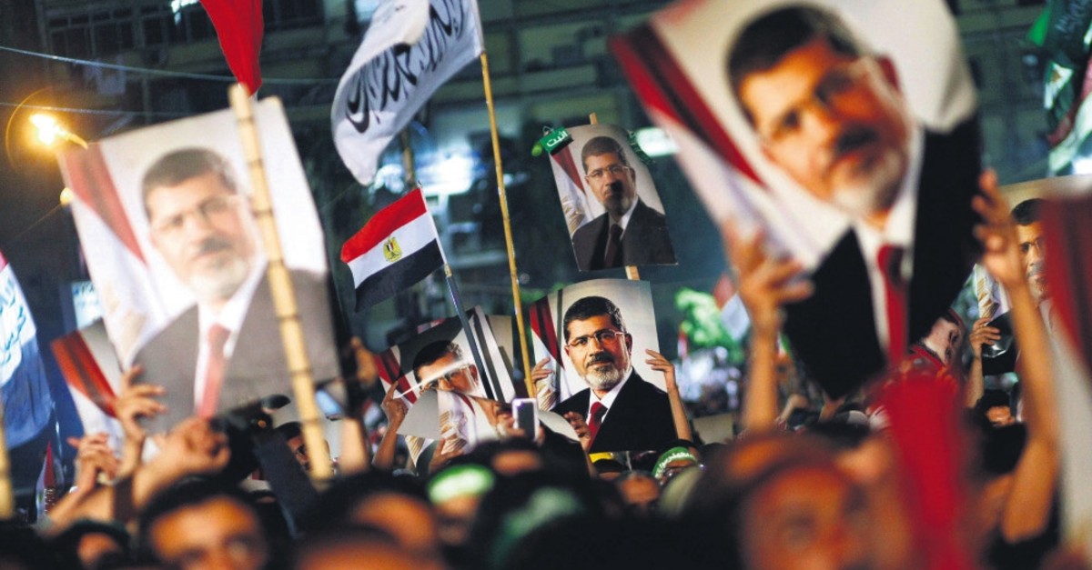 People hold the portrait of ousted Egyptian President Mohammed Morsi during a rally against the military coup that overthrew Morsi and put him into jail, Cairo, Egypt. July 4, 2013.