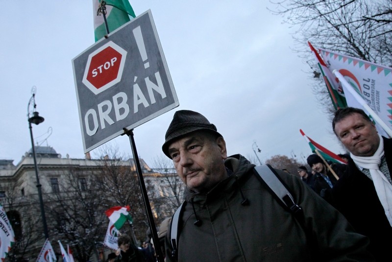 A protester holds a sign reading ,Stop Orban, as members and sympathisers of several trade unions, political parties and civil organisations march in Budapest on December 16, 2018. (AFP Photo)