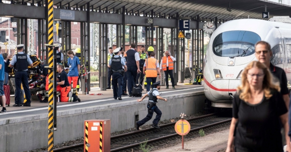 Firefighters and Police officers stay next to an ICE high-speed train at the main station in Frankfurt, Germany, Monday, July 29, 2019. (AP Photo)