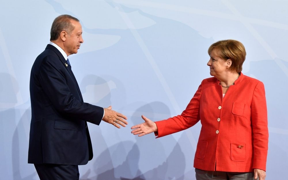 German Chancellor Angela Merkel greets President Recep Tayyip Erdou011fan at the beginning of the G20 Summit in Hamburg, Germany, July 7, 2017.