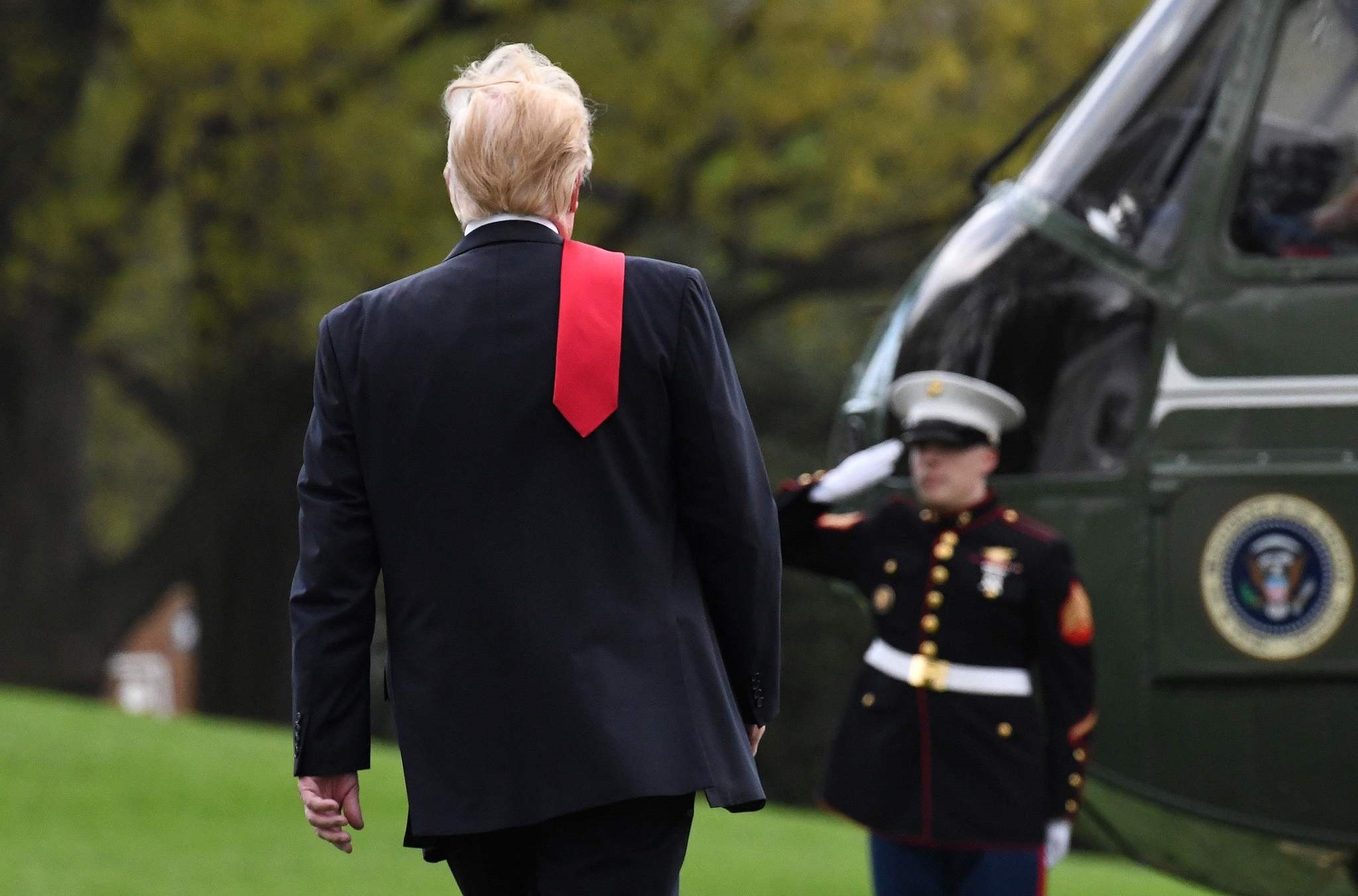 U.S. President Donald Trump walks toward Marine One while departing from the White House, April 28.