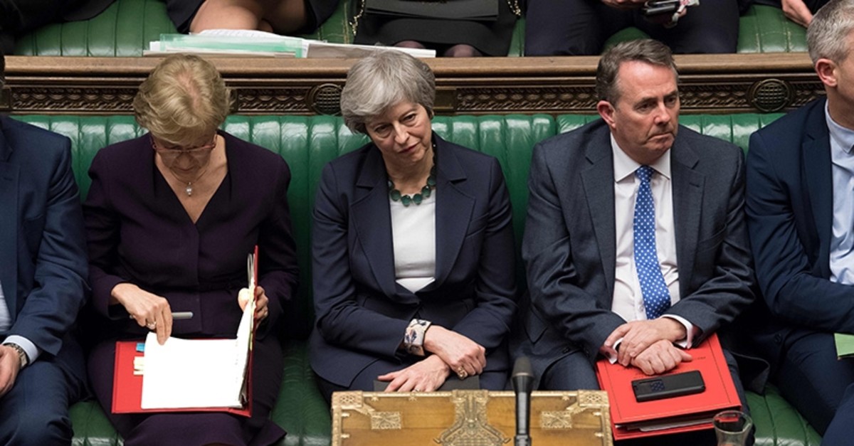 A handout photograph released by the U.K. Parliament on March 13, 2019 shows Britain's Prime Minister Theresa May reacting on the front bench in the House of Commons in London on March 13, 2019. (AFP Photo)