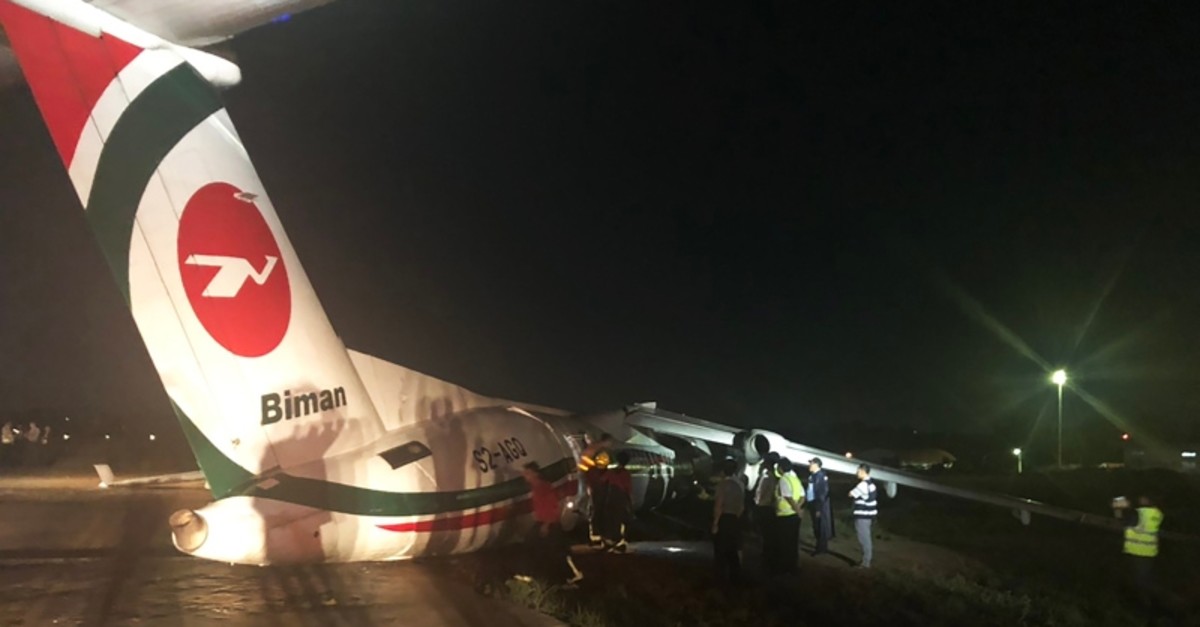 This handout picture taken and released by Myanmar Department of Civil Aviation on May 8, 2019 shows a Biman Bangladesh airlines passenger after it slid off a runway at Yangon International airport in Yangon. (AFP Photo)
