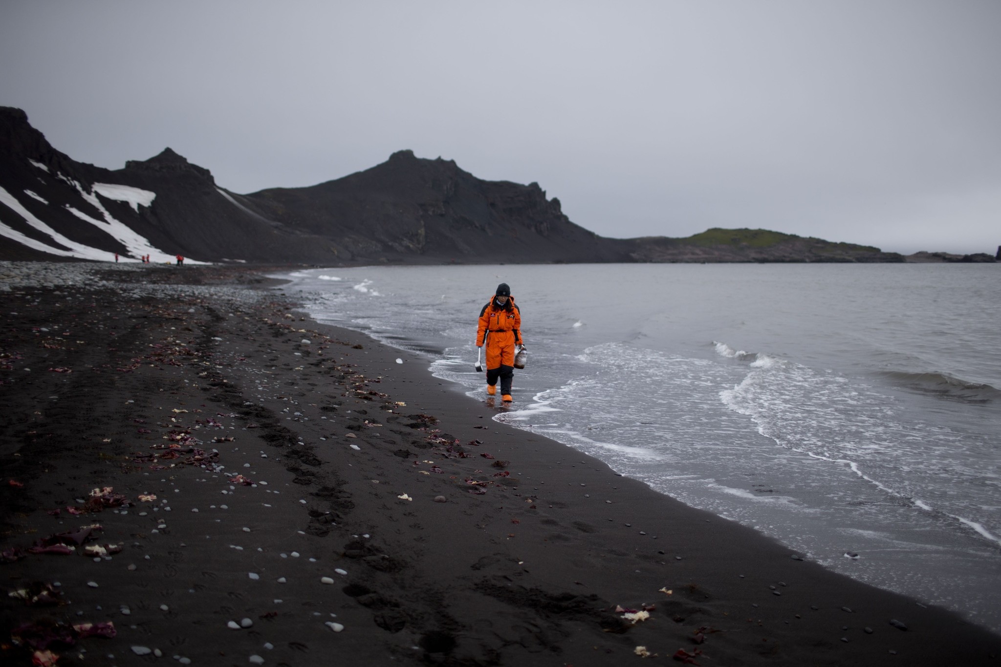 A marine chemist from China, walks along the beach in search of samples in Punta Hanna, Livingston Island, South Shetland Islands archipelago, Antarctica. (AP Photo)