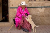In this Aug. 23, 2018 photo, 117-year-old Julia Flores Colque plays with ,Chiquita,, one of the family pet dogs, while sitting outside her home in Sacaba, Bolivia. (AP Photo)