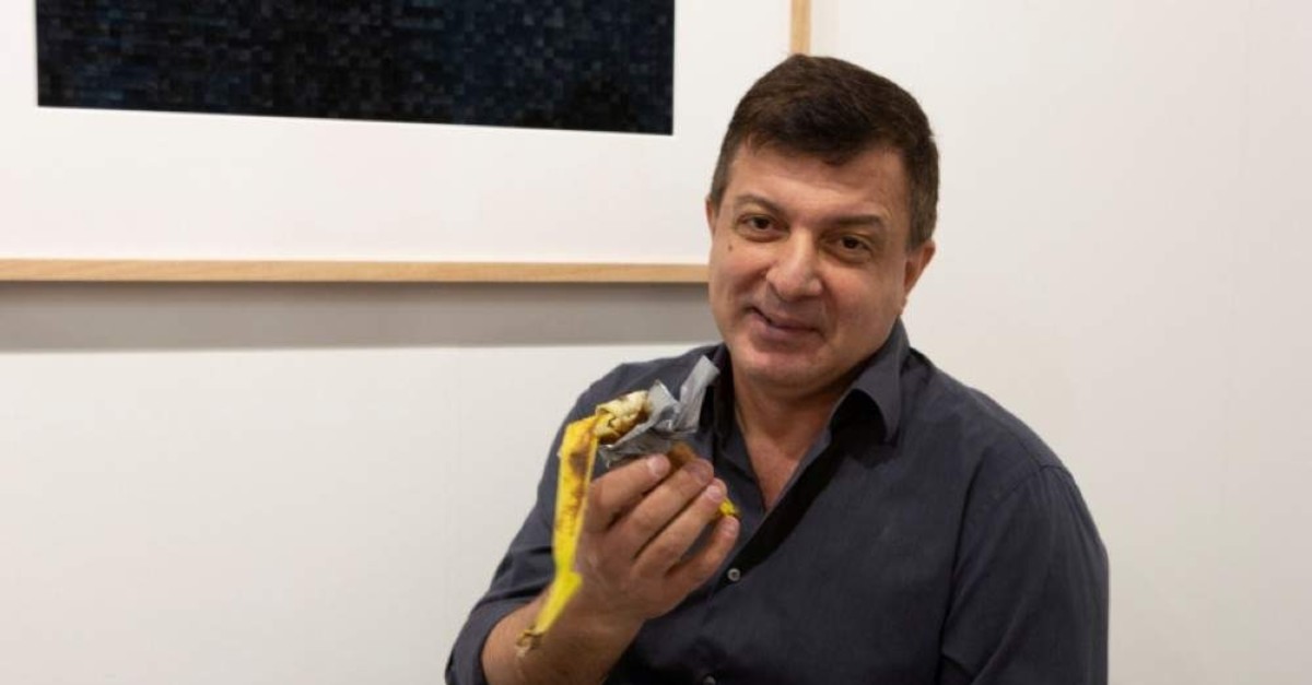 David Datuna shows the remains of the artwork ,Comedian, by the artist Maurizio Cattelan at the Perrotin stand in Art Basel in Miami Beach, Florida, Dec.7, 2019.  (REUTERS)