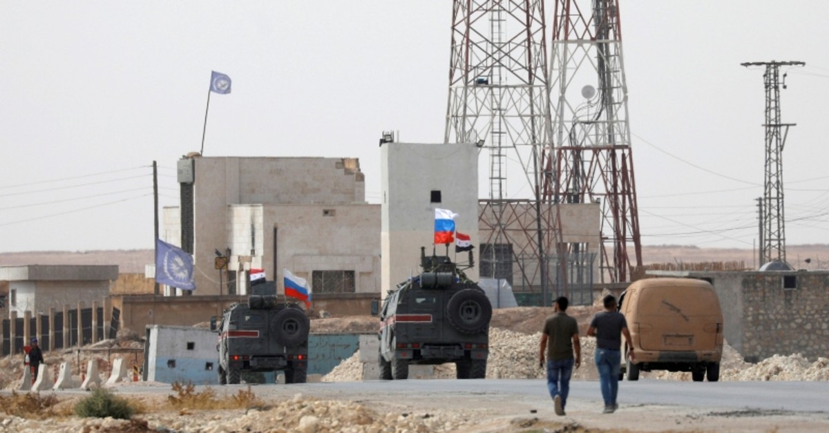 Russian and Syrian national flags flutter on military vehicles near Manbij, Syria, Oct. 15, 2019. (Reuters Photo)