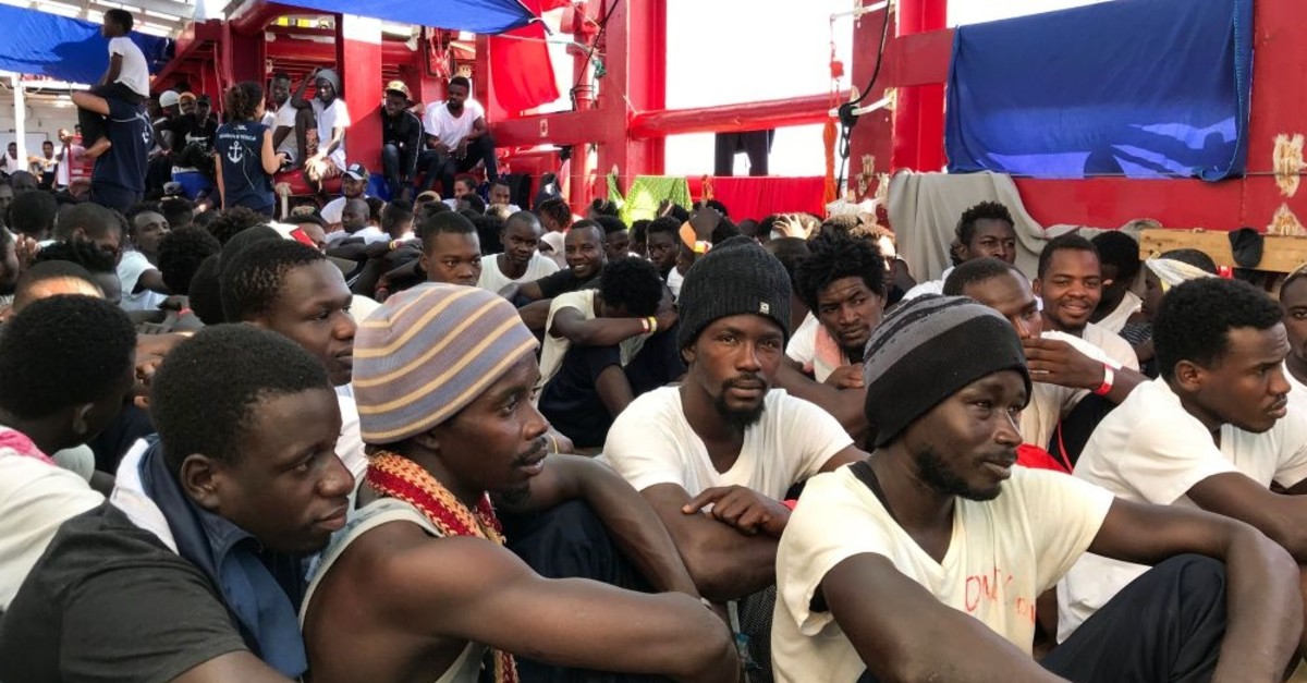 Migrants gather on a rescue ship after a search-and-rescue operation in the Mediterranean Sea, Aug. 23, 2019.
