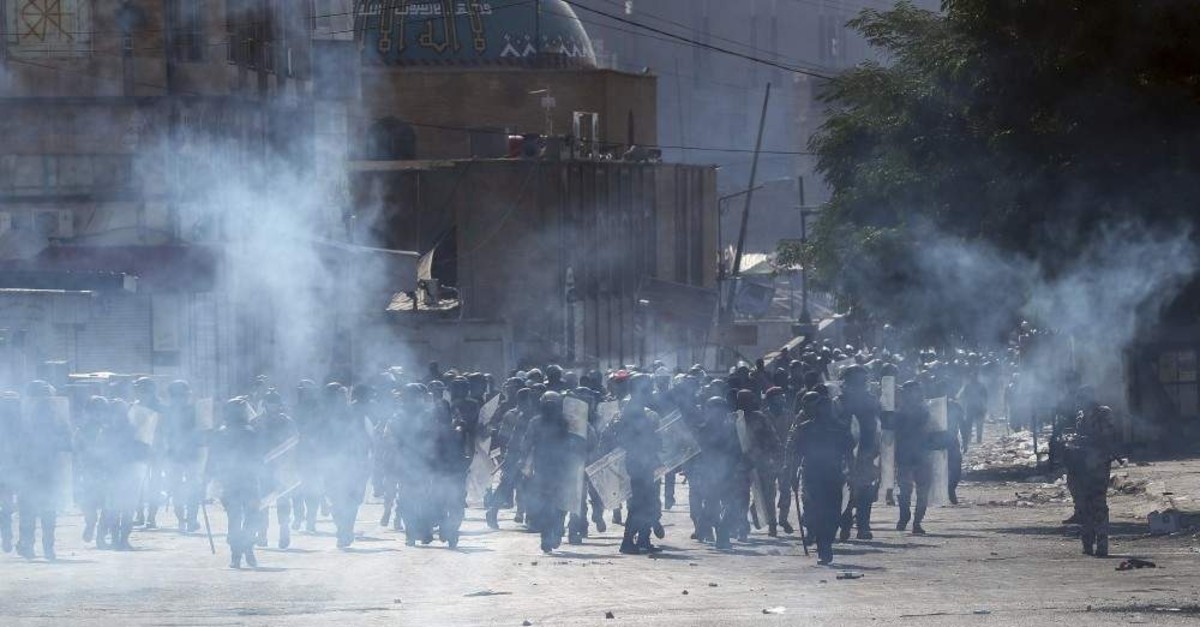 Iraqi riot police fire tear gas to disperse anti-government protesters, Baghdad, Nov. 7, 2019. (AP Photo)
