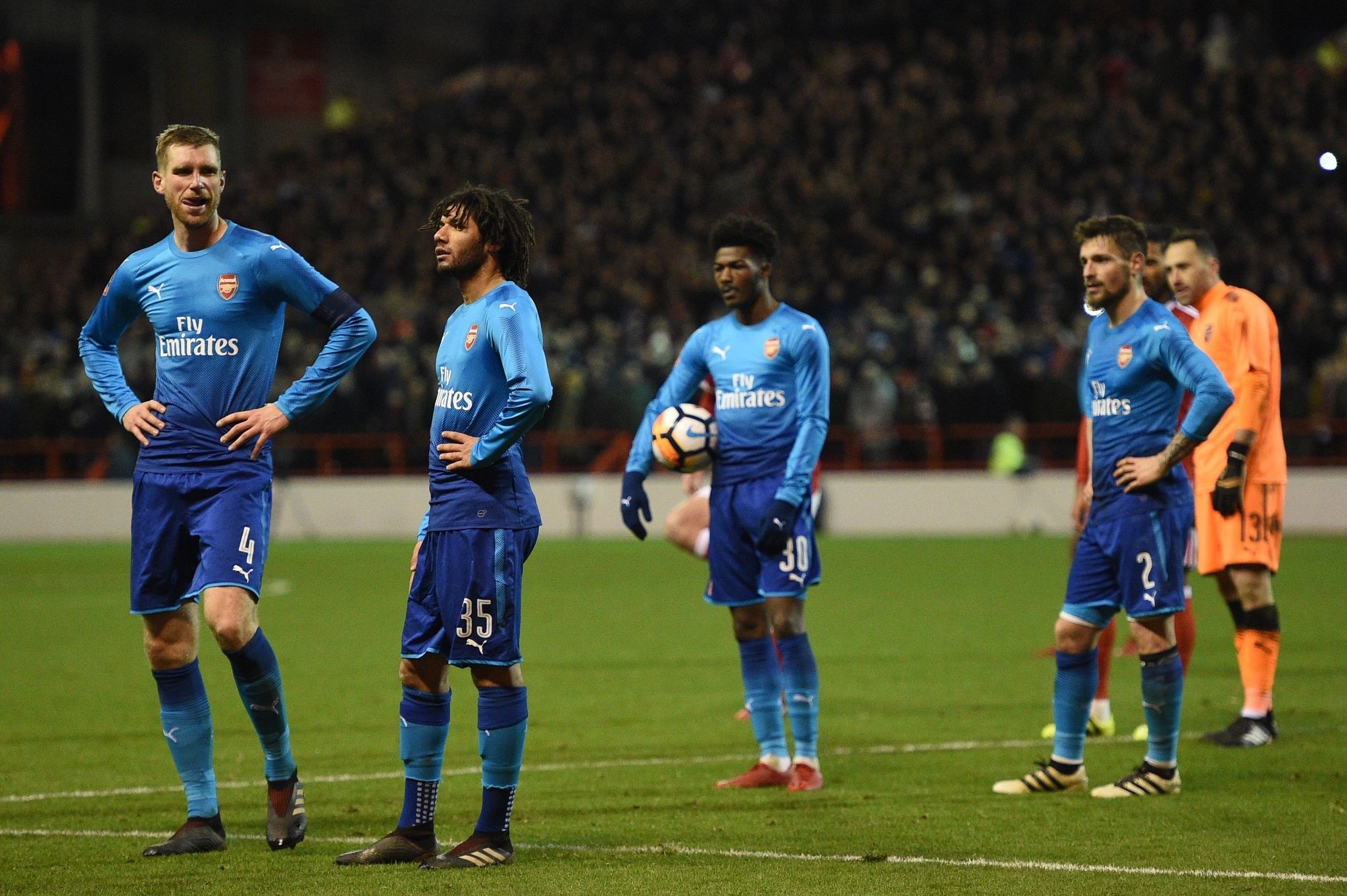 Arsenal players react to the awarding of the second penalty to Nottingham Forest during the English FA Cup third round football match between Nottingham Forest and Arsenal at The City Ground in Nottingham, central England, on January 7, 2018. (AFP Ph