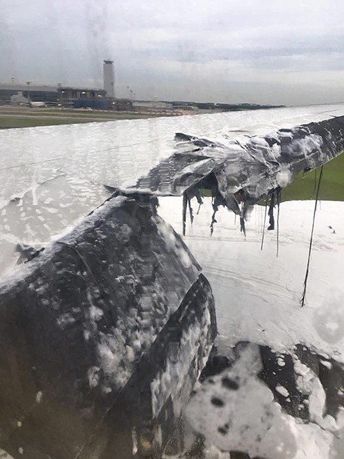 This handout image taken from video, shows foam everywhere after firefighters put out a fire on the right wing of a Singapore Airlines plane, on the tarmac of Singapore's Changi Airport. (AFP Photo)