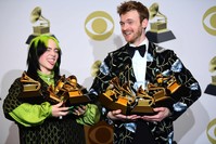 U.S. singer-songwriter Billie Eilish (L) and brother U.S. producer Finneas accept the award for Song Of The Year for ,Bad Guy, during the 62nd Annual Grammy Awards on January 26, 2020, in Los Angeles. (AFP Photo)