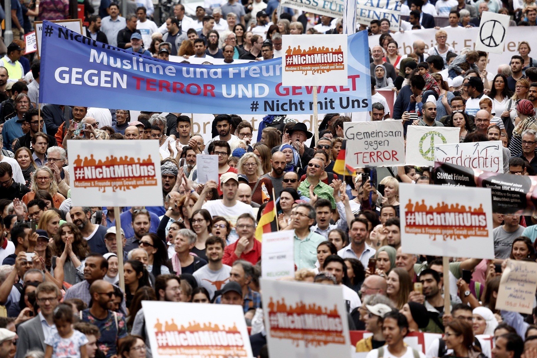 Participants carry a banner reading u201cMuslims and Friends against Terror and Violenceu201d as they take part u201cThe Not With Usu201d rally against the rising anti-Islam sentiment and extremism in Cologne, Germany, June 17.