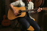 Employee Emily Meixell plays a guitar made with rosewood at C. F. Martin and Co., Pennsylvania.