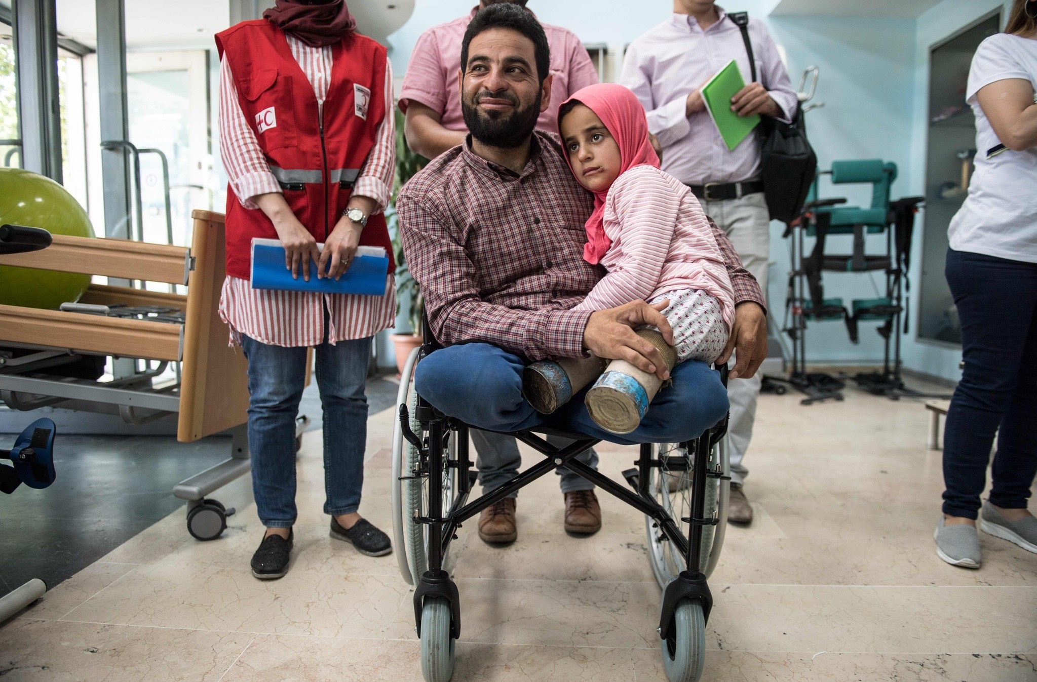 Eight-year-old Syrian girl Maya and her father, born without legs, arrive to an Istanbul clinic on June 29, 2018, to get prosthetic legs after being evacuated from Syria. (AFP Photo)