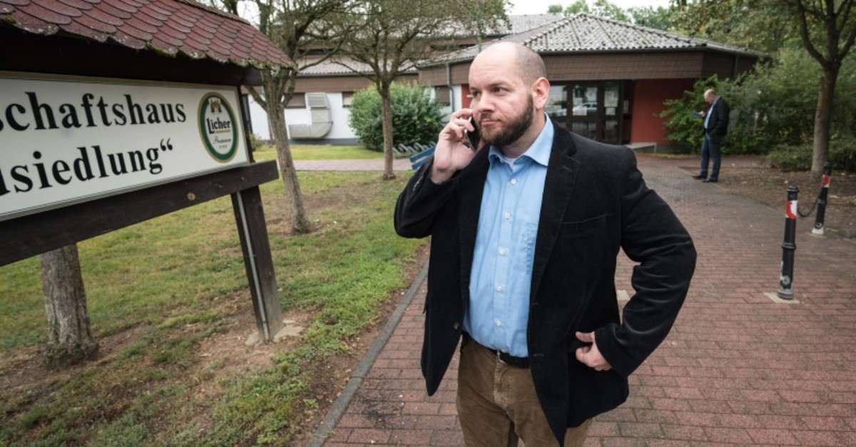 Stefan Jagsch of the far right-wing extremist National Democratic Party (NDP) speaks on the telephone in front of the community house in Altenstadt-Waldsiedlung, on September 8, 2019 (AFP Photo)