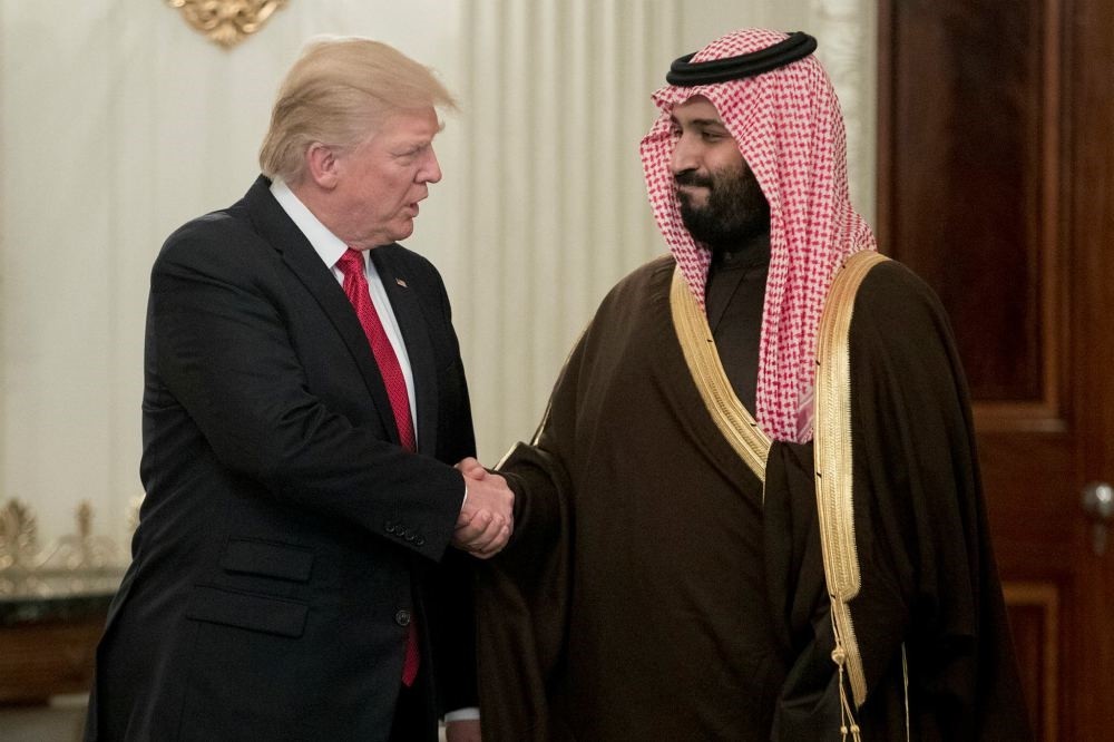 US President Donald Trump shakes hands with Deputy Crown Prince and Defense Minister Mohammed bin Salman bin Abdulaziz Al Saud before a lunch in the State Dining Room of the White House in Washington, DC, March 14.