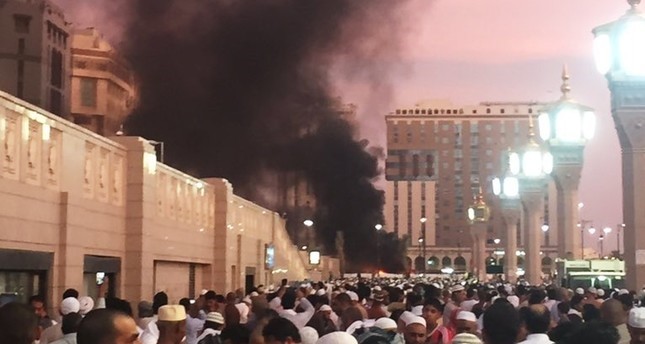 In this photo provided by Noor Punasiya, people stand by an explosion site in Medina, Saudi Arabia, Monday, July 4, 2016. (AP Photo)