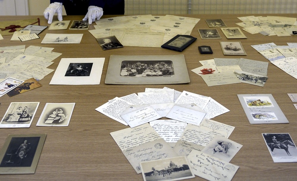 An employee at a museum in Tsarskoye Selo, the former summer residence of the tsars on the outskirts of Saint Petersburg, displays part of the collection of documents revealing the everyday life of the imperial Romanov family.