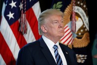 President Donald Trump listens as Treasury Secretary Steve Mnuchin speaks at the Treasury Department in Washington on April 21. (AP Photo)