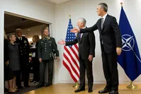 U.S. Secretary for Defense Jim Mattis (2-R) and NATO Secretary-General (R) Jens Stoltenberg gesture to delegation members outside the room prior to a meeting on the sidelines of a NATO defense ministers meeting at NATO headquarters, Brussels, Nov. 8.