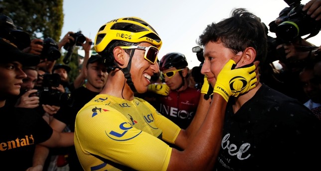 Team INEOS rider Egan Bernal of Colombia, wearing the overall leader's yellow jersey, celebrates after the finish. (Reuters Photo)