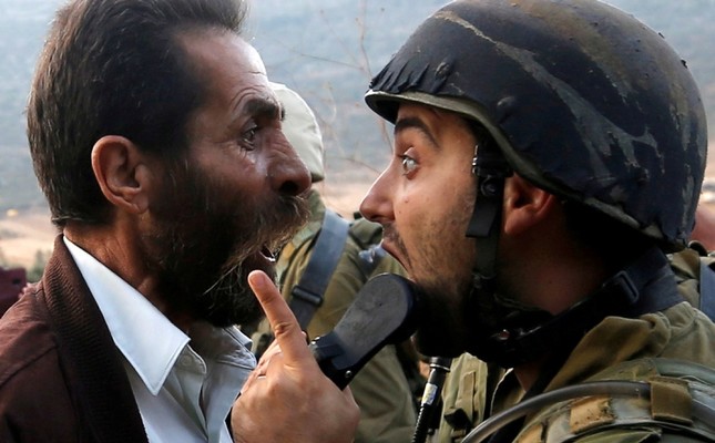 A Palestinian man argues with an Israeli soldier during clashes over an Israeli order to shut down a Palestinian school near Nablus in the occupied West Bank, Oct. 15, 2018. (Reuters Photo)