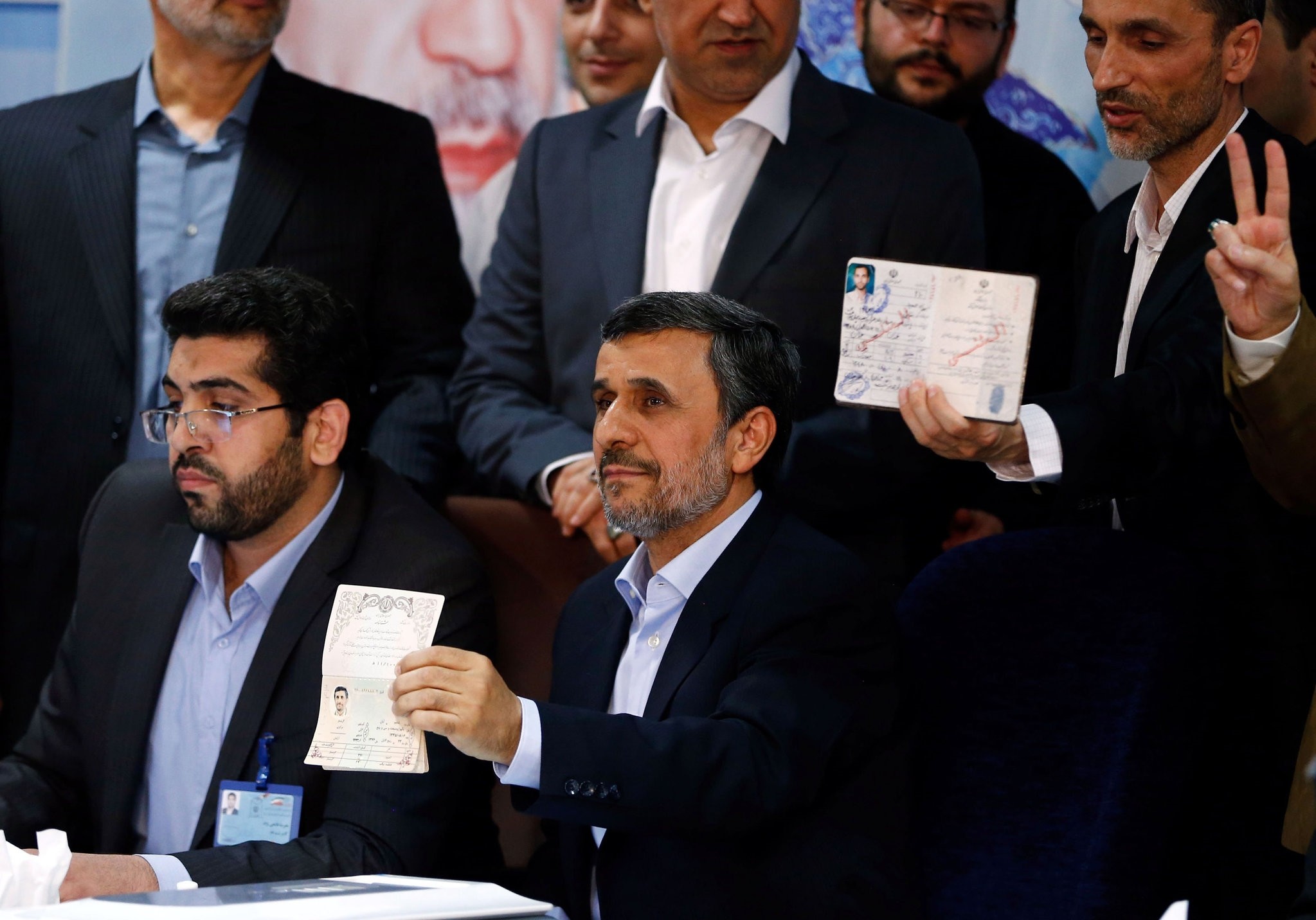 Former Iranian president Mahmoud Ahmadinejad (C) displays identification at the Interior Ministry's election headquarters as candidates begin to sign up for the upcoming presidential elections in Tehran on April 12, 2017. (AFP Photo)