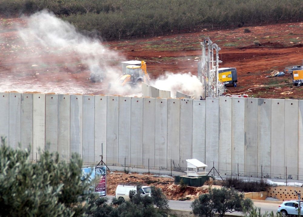 Israeli machinery operates behind the Israel-Lebanon border wall, Dec. 4.