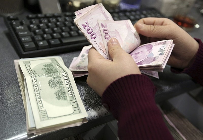 In this file photo taken Tuesday, Jan. 28, 2014, a woman counts U.S. dollar and Turkish lira banknotes at a currency exchange office in Istanbul, Turkey. (AP Photo)