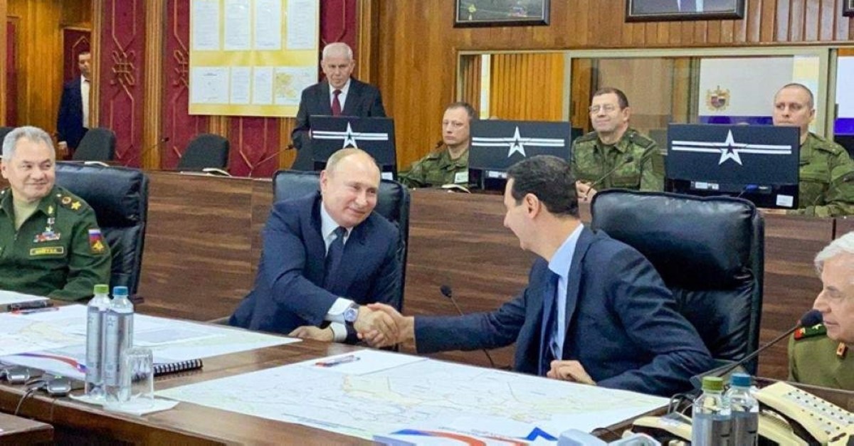 A handout picture released by the official Syrian presidency Telegram page on January 7, 2020 shows Assad (C-R) shaking the hand of Putin (C-L) at the headquarters of the Russian forces in Damascus. (AFP Photo) 