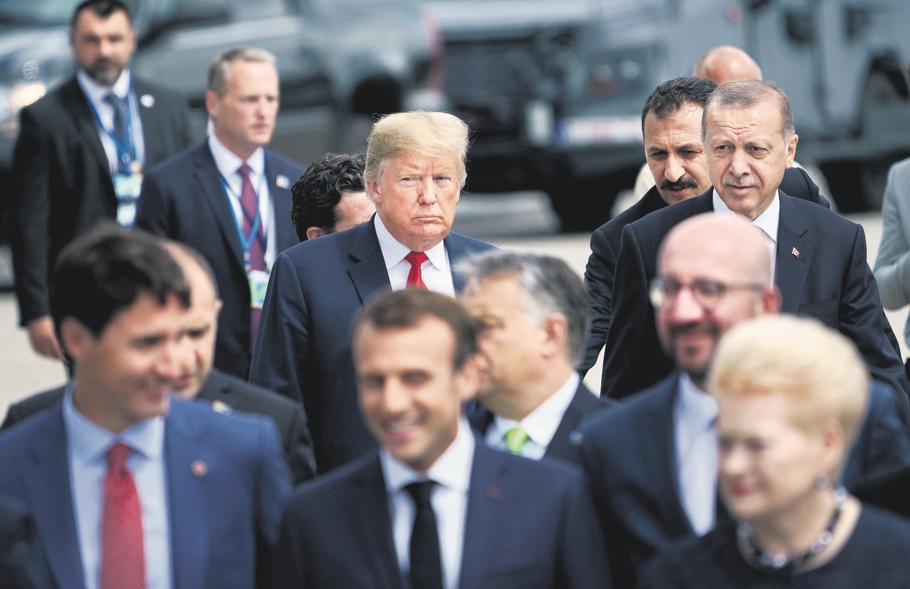 U.S. President Donald Trump (L) and President Recep Tayyip Erdou011fan (R) follow other leaders to a u201cfamily photo u201cduring the summit at NATO headquarters, Brussels, July 11. 