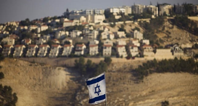 An Israeli flag is seen in front of the illegal Jewish settlement of Maaleh Adumim in West Bank, on the outskirts of Jerusalem, in this 2009 file photo (AP)