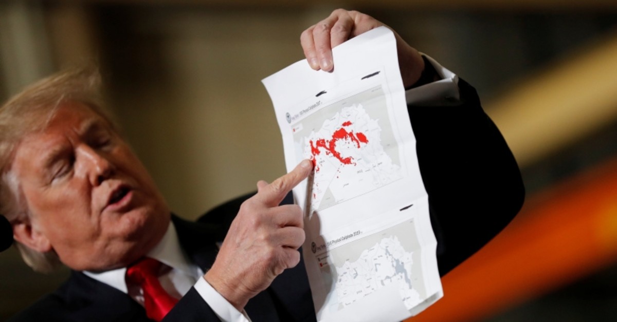 U.S. President Donald Trump shows maps depicting the size of the so-called ,ISIS physical caliphate, as he talks to reporters upon departing on travel to Ohio from the White House in Washington, U.S., March 20, 2019.  (Reuters Photo)