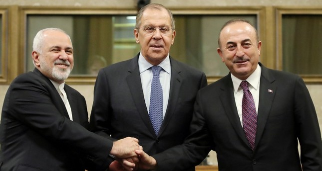 Russian Foreign Minister Lavrov, Turkish Foreign Minister Çavuşoğlu and Iranian Foreign Minister Zarif shake hands as they attend a news conference after talks on forming a constitutional committee in Syria, at the U.N. in Geneva. (REUTERS Photo)